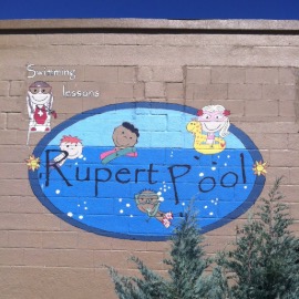 Rupert Pool mural painted on side of tan brick building